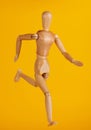 Running wooden doll