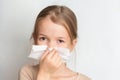 Runny nose in children. A child blows his nose in a handkerchief. Royalty Free Stock Photo