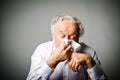 Runny nose. Old man is sneezing. Royalty Free Stock Photo