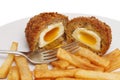 Runny scotch egg and chips Royalty Free Stock Photo