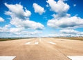 Runway, airstrip in the airport terminal with marking on blue sky with clouds background. Travel aviation concept...