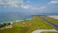 Runway at Denpasar International Airport in Bali, Indonesia. Runway reaching into the ocean. Aerial view to Ngurah Rai