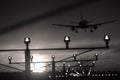 Silhouette of plane landing, runway lights Royalty Free Stock Photo