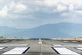 Runway with mountain in the background in cloudy day