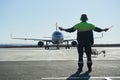 The runway traffic controller uses gestures and sticks to help the aircraft choose the correct trajectory around the airfield