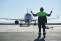 The runway traffic controller uses gestures and sticks to help the aircraft choose the correct trajectory around the airfield