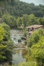 RUPIT and PRUIT, SPAIN - JULY, 2020: Medieval town of Rupit, with river and waterfall between the houses and the green forest