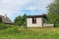 Rural abandoned broken shed near summer forest