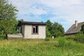 Rural abandoned broken shed near summer forest