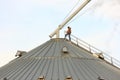 Rural American Man On Top Of Metal Grain Bin