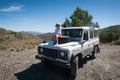 Rural Andalucia. Spain. 06/10/2016. Little girl admiring views while sitting on front spare tyre on a bonnet hood in 4x4 terrain v