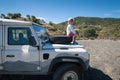 Rural Andalucia. Spain. 06/10/2016. Little girl admiring view while sitting on front spare tyre on a bonnet hood in 4x4 terrain.