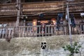 Rural Asian children stand on terrace of Chinese wooden farmhouse
