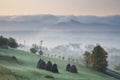 rural autumn landscape with fog and hay stacks Royalty Free Stock Photo