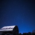 Rural barns at night with stars in winter Royalty Free Stock Photo