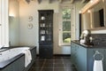 Rural bathroom in grey blue with black tiling Royalty Free Stock Photo