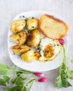 Rural breakfast - fried eggs, new potatoes, radish Royalty Free Stock Photo