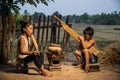 Rural children playing with blowing music and laughter. People Thailand. Boys and girls playing folk music with local instruments Royalty Free Stock Photo