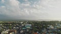 Rural city at Mayon volcano erupt aerial. Contryside town at green valley. Cottages at streets