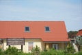 Rural cottage with red metal roof and attic skylight windows