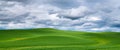 Rural countryside of idyllic green hills under a dramatic sky Royalty Free Stock Photo