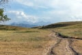Rural dirt road, hills and mountains Royalty Free Stock Photo