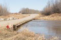 A rural dirt road with rising flood waters