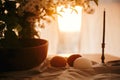 Rural Easter still life. Natural eggs and vintage candle on linen fabric on background of rustic table with cherry flowers and