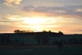 orange sky above a dark hill during dawn