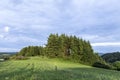 Rural Eifel landscape with forest and green meadow