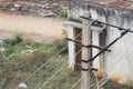 Rural Electric power cables carry electricity on a concrete pole outdoors on a sunny day