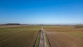 Rural Expanse: Straight Road Cutting through Farmland Royalty Free Stock Photo