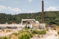Deteriorating factory and smokestack on the outskirts of Barcelona