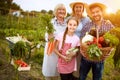 Rural family satisfied with vegetables products from garden