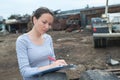 Rural female technician writing reading meter on clipboard outdoors