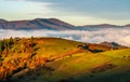 Rural fields over the clouds in mountains at sunrise Royalty Free Stock Photo