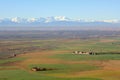 Rural fields and snow covered mountains Royalty Free Stock Photo