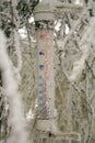 The rural garden in winter clothes. Frosted thermometer hanging on the larch showing the temperature below zero. Royalty Free Stock Photo
