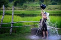 Rural girl is taking a shower from a traditional Groundwater at Royalty Free Stock Photo