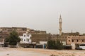 Rural gouses in the city of Esna with minaret under light sky