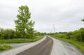 Rural gravel country road on a cloudy day landscape