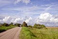 Rural gravel road and house in distance