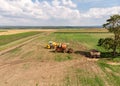 Rural harvesters stand on wide field. Agriculture landscape