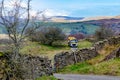 Rural highway maintenance road maintenance repair work on potholes on country lane tarmac asphalt in Lake District, England