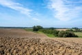 Rural, hilly landscape with freshly ploughed field in autumn. Fresh plowed ararian field Royalty Free Stock Photo