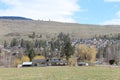 Rural house in field with houses on hill background Royalty Free Stock Photo