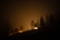Rural house in fog at night in the mountains Royalty Free Stock Photo