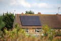 A rural house that has had solar panels installed on the roof to generate renewable clean green energy Royalty Free Stock Photo