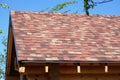 Rural house from smooth logs amd soft motley roof tille side view Royalty Free Stock Photo