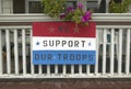 A rural house with We Support Our Troops sign